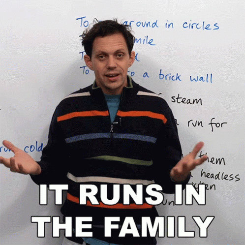 a man standing in front of a white board with the words it runs in the family